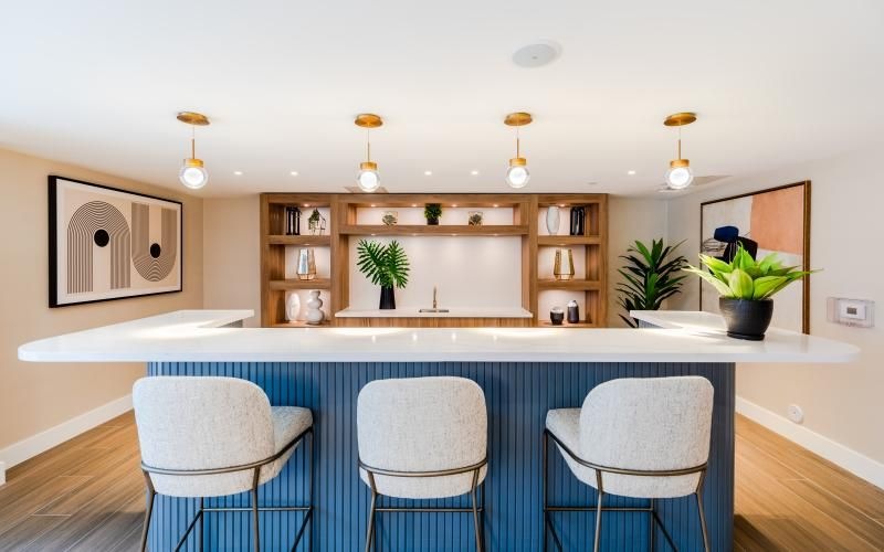 a kitchen with a bar and chairs