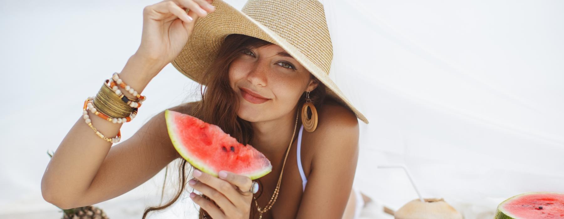 a woman holding a watermelon