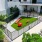 a courtyard with a fence and a building with a red car parked in it