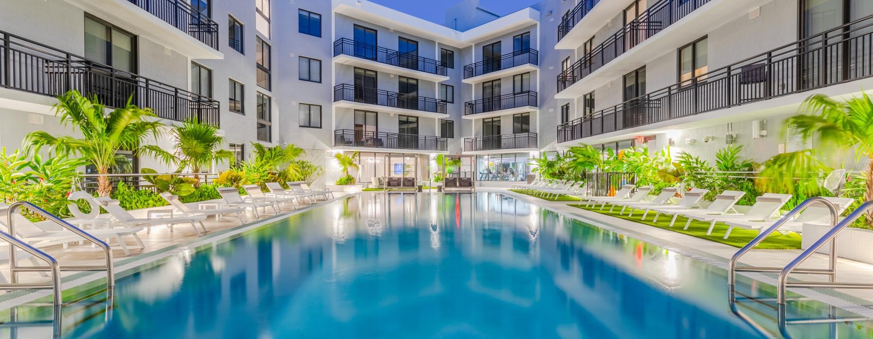 a pool in a courtyard between buildings